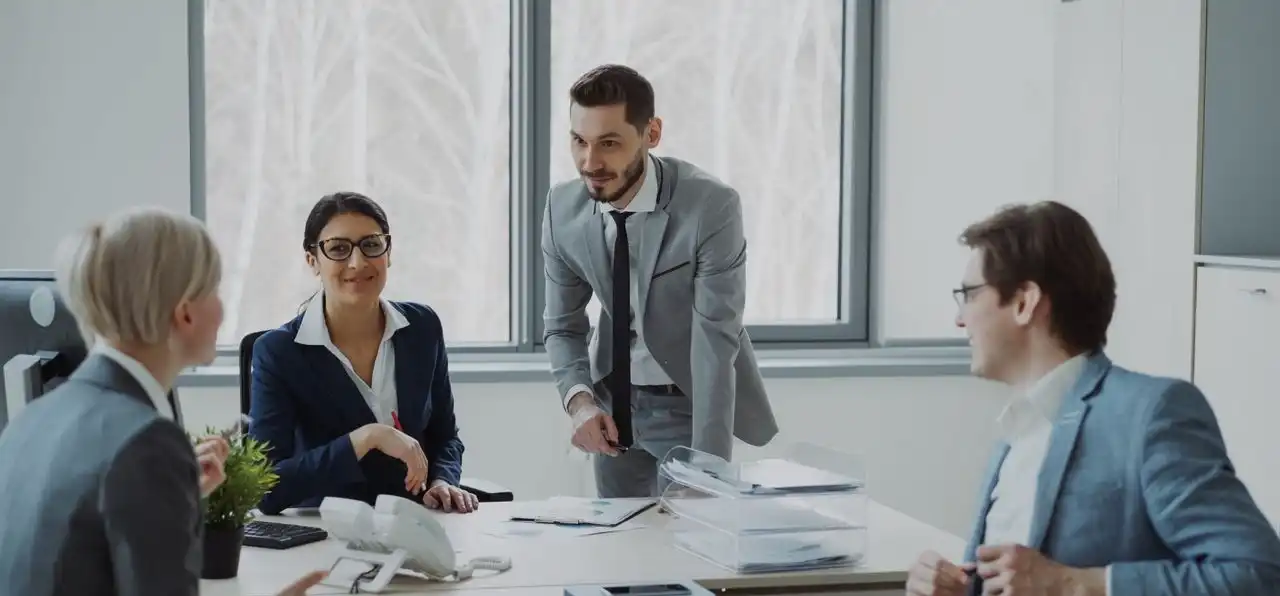 Group of professionals in a modern office setting discussing business strategies.